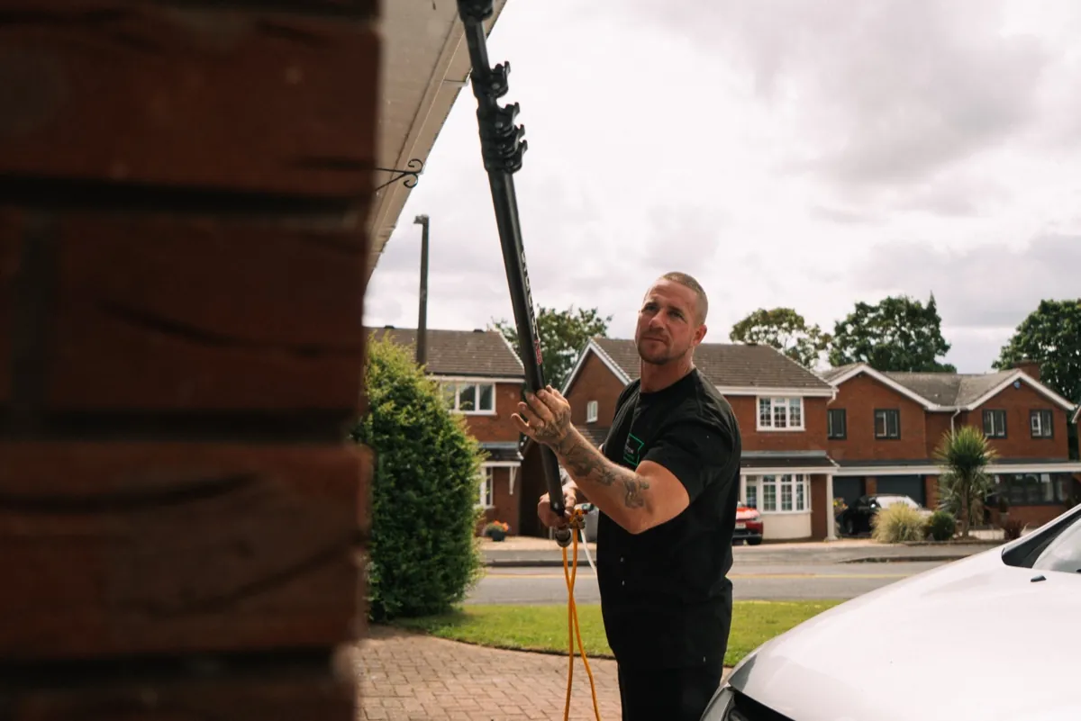 Telescopic pole reaching up to the roofline and gutters of a Tamworth home