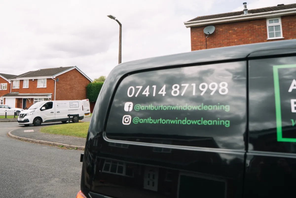 Two Ant Burton liveried vans working the same Tamworth street, phone number and social handles on the rear glass